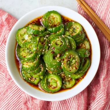 A vibrant Asian cucumber salad with fresh vegetables and a zesty dressing.