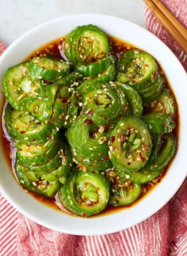 A vibrant Asian cucumber salad with fresh vegetables and a zesty dressing.