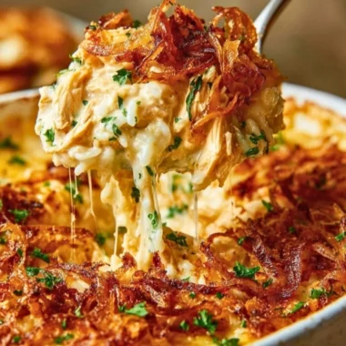 Plate of French Onion Chicken Rice garnished with herbs