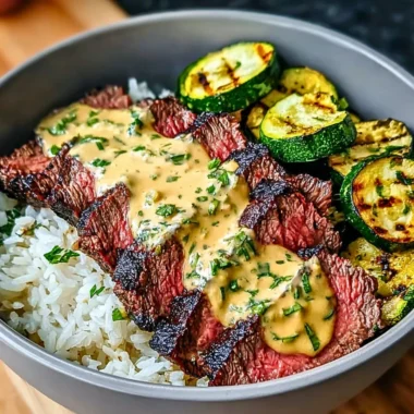 Grilled Steak Bowl with sauce and grilled zucchini on a plate