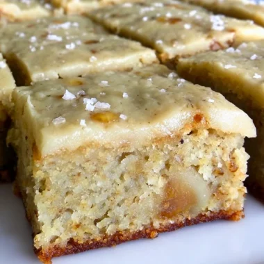 Delicious banana bread brownies topped with brown butter frosting on a plate