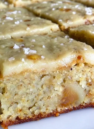 Delicious banana bread brownies topped with brown butter frosting on a plate