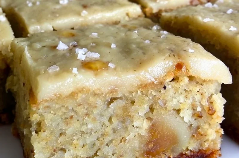 Delicious banana bread brownies topped with brown butter frosting on a plate