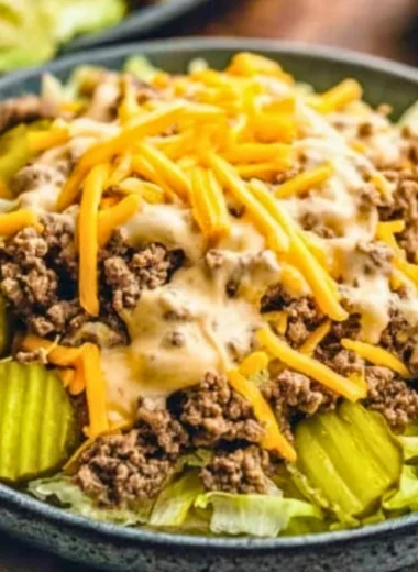 Keto Big Mac Salad topped with lettuce, cheese, and special sauce