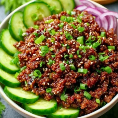 Spicy Keto Korean Beef served with a fresh cucumber salad for a low-carb meal
