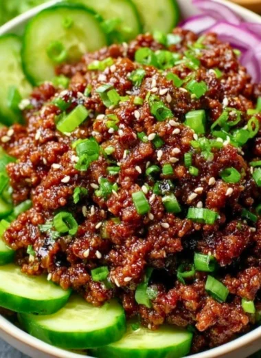 Spicy Keto Korean Beef served with a fresh cucumber salad for a low-carb meal