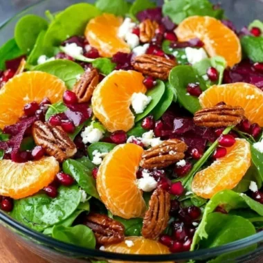 Colorful winter salad with seasonal ingredients like kale, pomegranate, and walnuts.