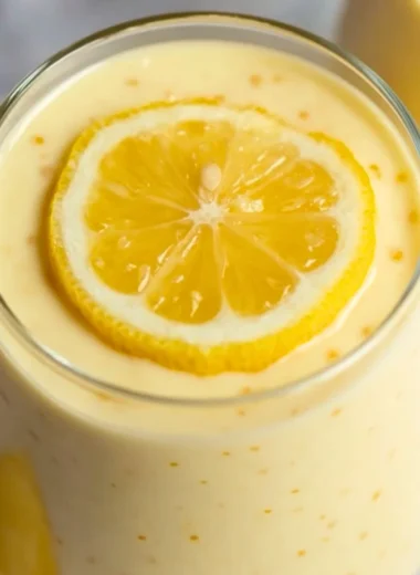 Delicious lemon cream chia pudding in a glass bowl topped with fresh lemons.