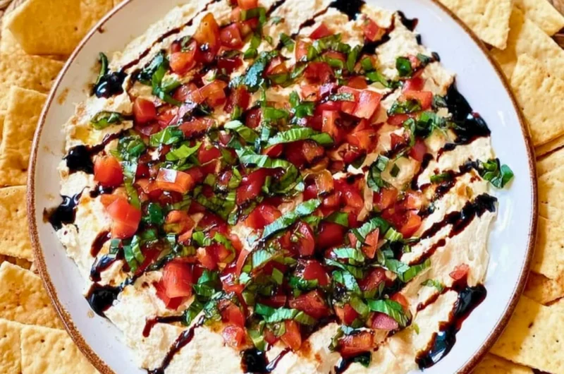 A bowl of delicious Bruschetta Dip with fresh tomatoes and herbs.