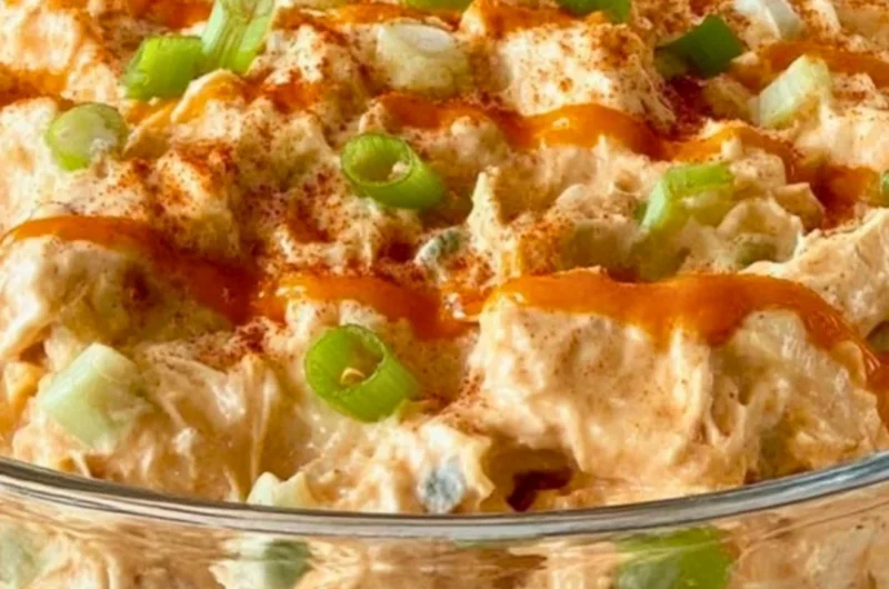 Plate of spicy Buffalo Chicken Salad with greens and veggies