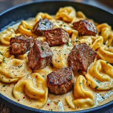 Delicious Cracked Garlic Steak Tortellini served in creamy sauce