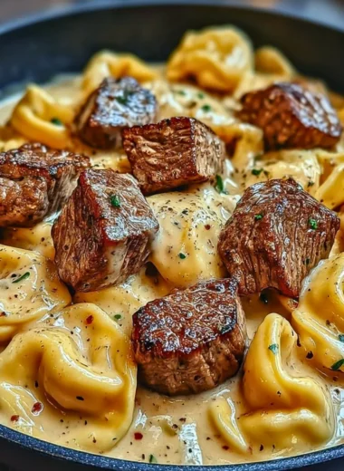 Delicious Cracked Garlic Steak Tortellini served in creamy sauce