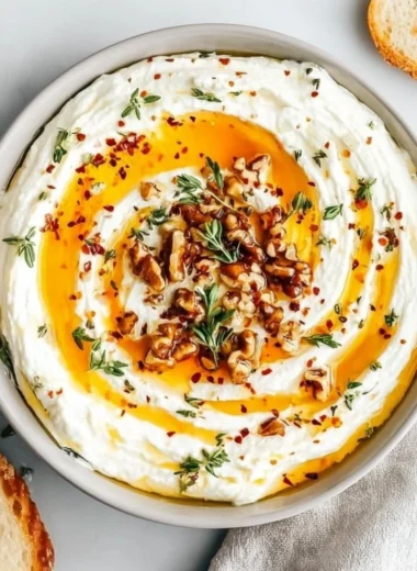 Delicious ricotta dip topped with hot honey in a serving bowl