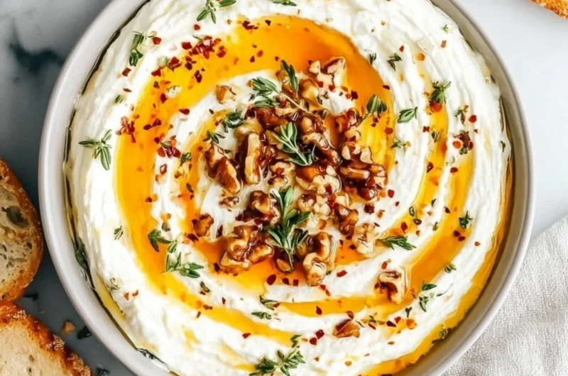 Delicious ricotta dip topped with hot honey in a serving bowl