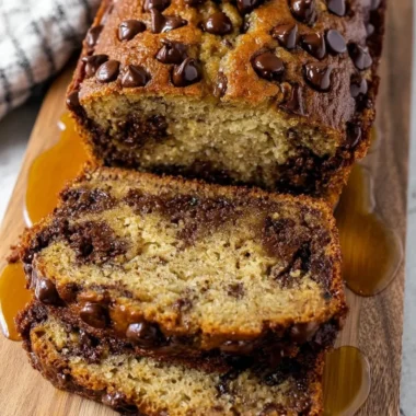 Slice of easy chocolate chip banana bread with chocolate chips and bananas
