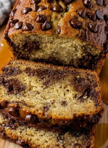 Slice of easy chocolate chip banana bread with chocolate chips and bananas