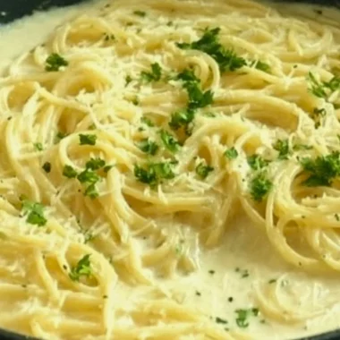 Creamy Garlic Parmesan Sauce served on pasta for a delicious dish.