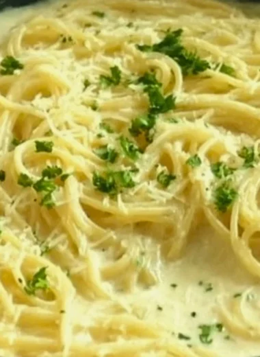 Creamy Garlic Parmesan Sauce served on pasta for a delicious dish.