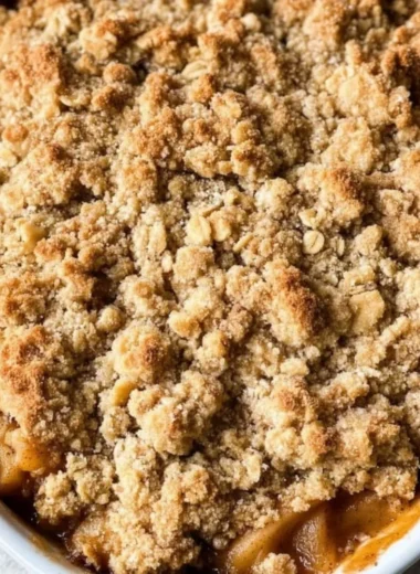 Delicious gluten-free apple crisp dessert topped with oats and nuts