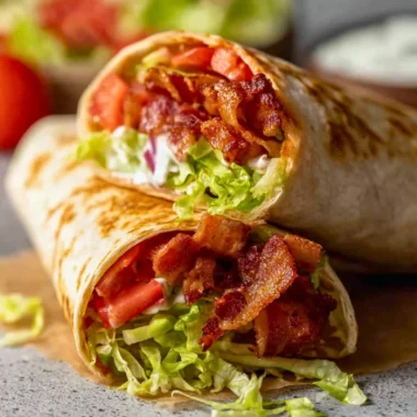 Healthy BLT wraps with fresh ingredients and a secret sauce on a plate.