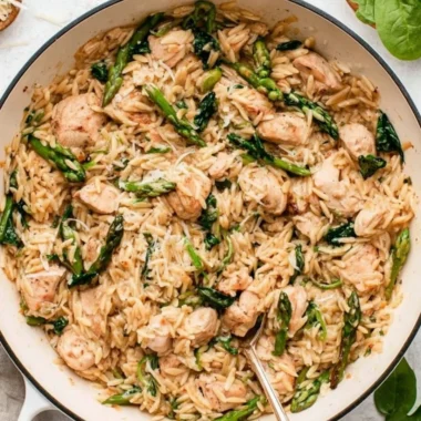 High protein chicken orzo dish served in a bowl with fresh herbs