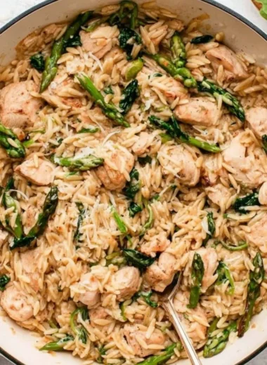 High protein chicken orzo dish served in a bowl with fresh herbs