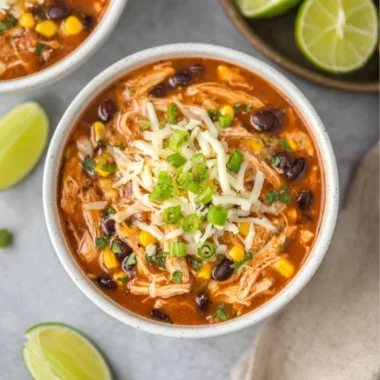 Delicious high protein chicken taco soup in a bowl with colorful toppings