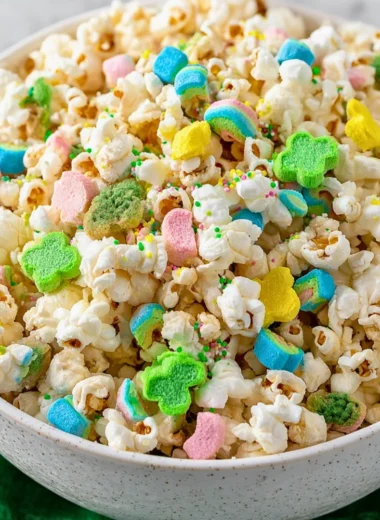 Loaded St. Patrick's Day popcorn with green chocolate and festive sprinkles