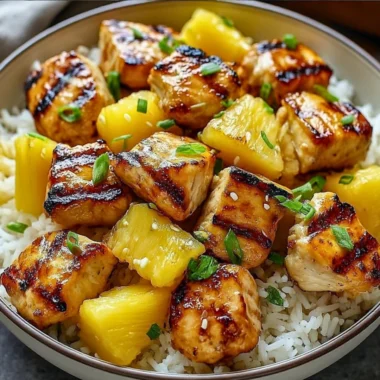 Pineapple chicken served with rice on a plate