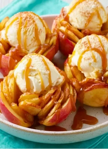 Slow Cooker Bloomin' Baked Apples served in a bowl, garnished with cinnamon.