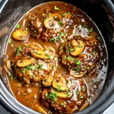 Delicious slow cooker Salisbury steak served with gravy and mashed potatoes