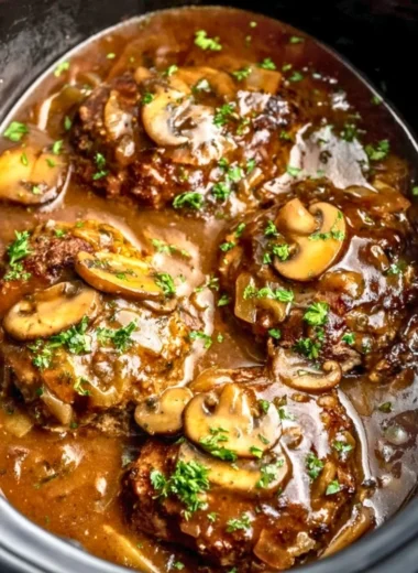 Delicious slow cooker Salisbury steak served with gravy and mashed potatoes