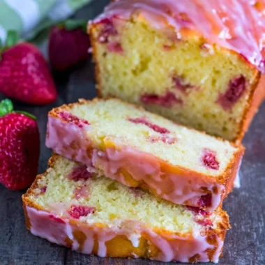 Freshly baked strawberry pound cake topped with ripe strawberries
