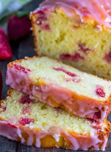 Freshly baked strawberry pound cake topped with ripe strawberries