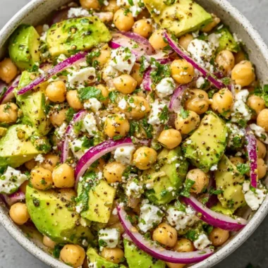 A vibrant Chickpea Feta Avocado Salad with fresh ingredients and colorful presentation.
