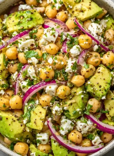 A vibrant Chickpea Feta Avocado Salad with fresh ingredients and colorful presentation.