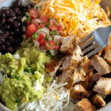 Grilled chicken burrito bowl with rice and beans served in a bowl