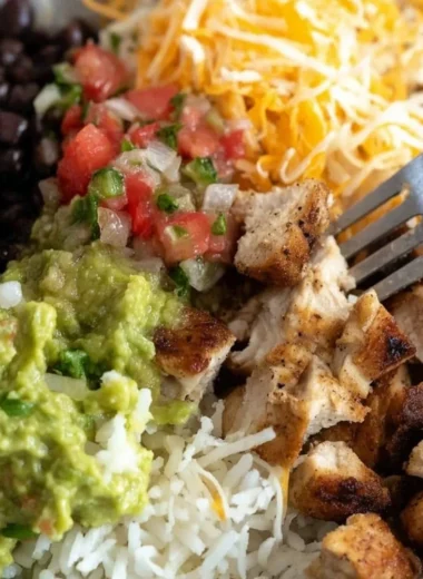 Grilled chicken burrito bowl with rice and beans served in a bowl