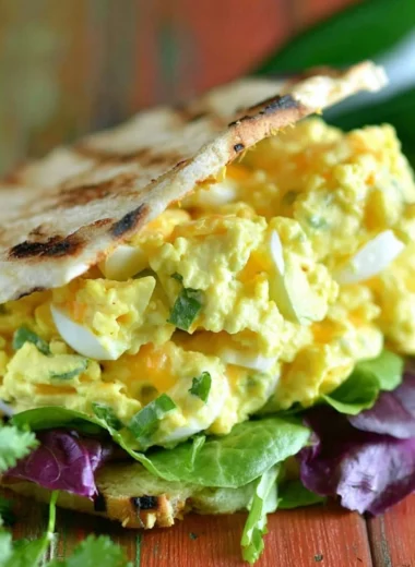 Jalapeno Cheddar Egg Salad served in a bowl with fresh herbs
