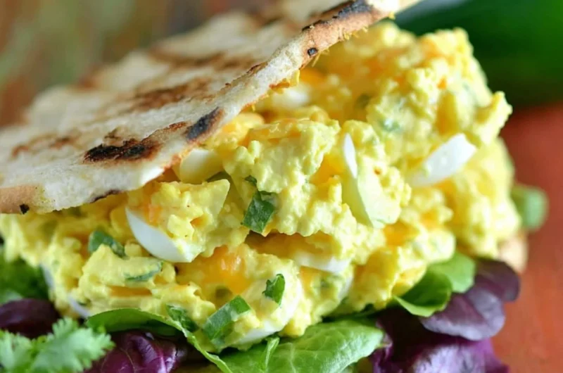 Jalapeno Cheddar Egg Salad served in a bowl with fresh herbs