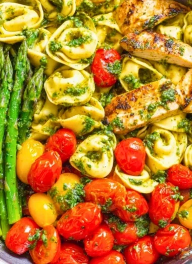 One-Pan Pesto Chicken with tortellini and colorful veggies for a quick meal.