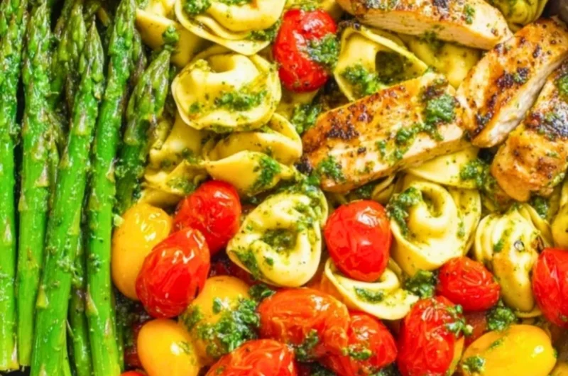 One-Pan Pesto Chicken with tortellini and colorful veggies for a quick meal.