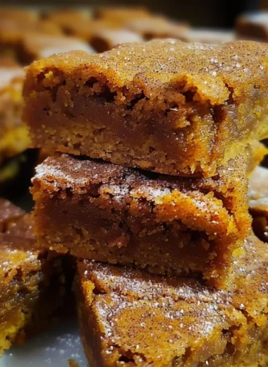 Freshly baked Pumpkin Snickerdoodle Blondies on a rustic wooden table