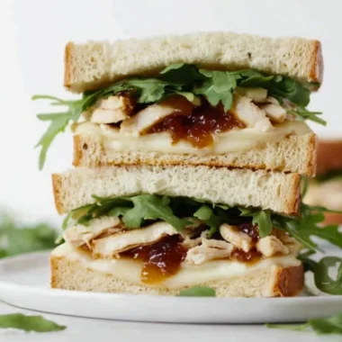 Tasty Apricot Brie Chicken Sandwich with fresh ingredients on a plate