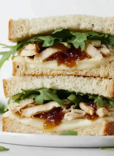 Tasty Apricot Brie Chicken Sandwich with fresh ingredients on a plate