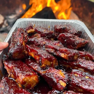 Delicious BBQ ribs served with sides on a rustic table