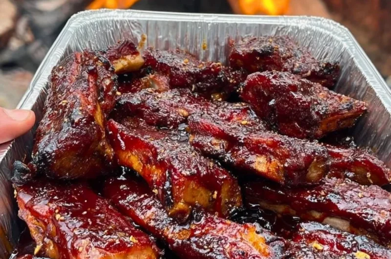 Delicious BBQ ribs served with sides on a rustic table
