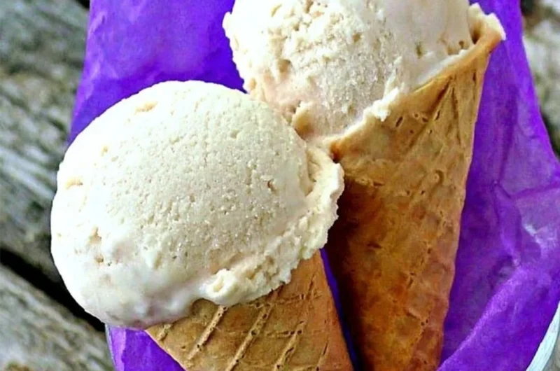 Delicious banana frozen yogurt topped with fresh banana slices and a mint garnish.
