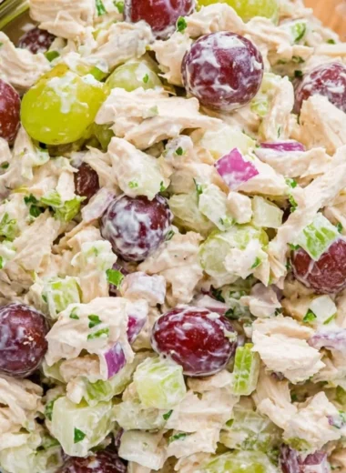 Delicious chicken salad served in a bowl with fresh ingredients and herbs