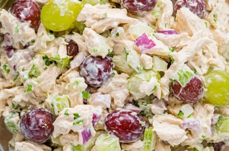 Delicious chicken salad served in a bowl with fresh ingredients and herbs
